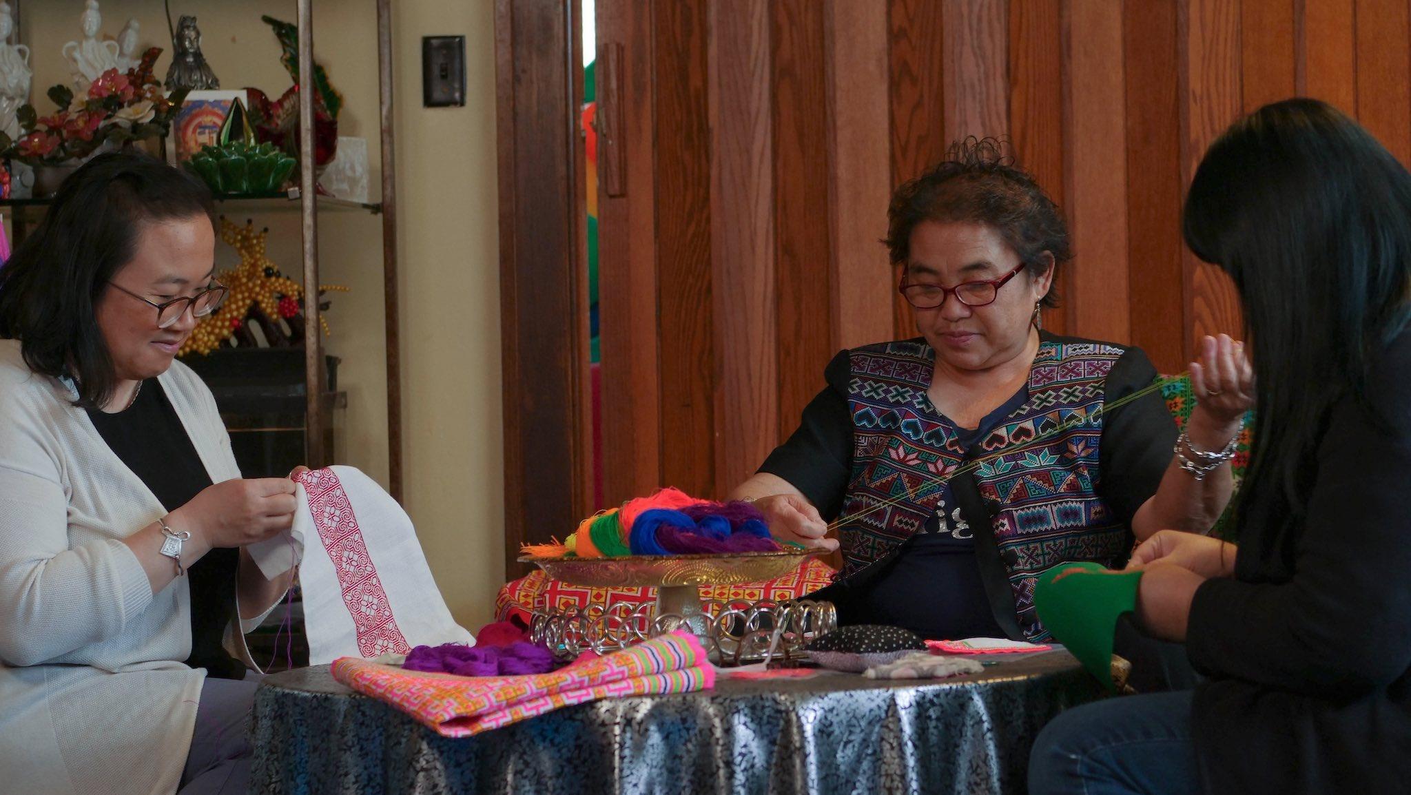 Hmong women embroidery paj ntaub (flower cloth embroidery)