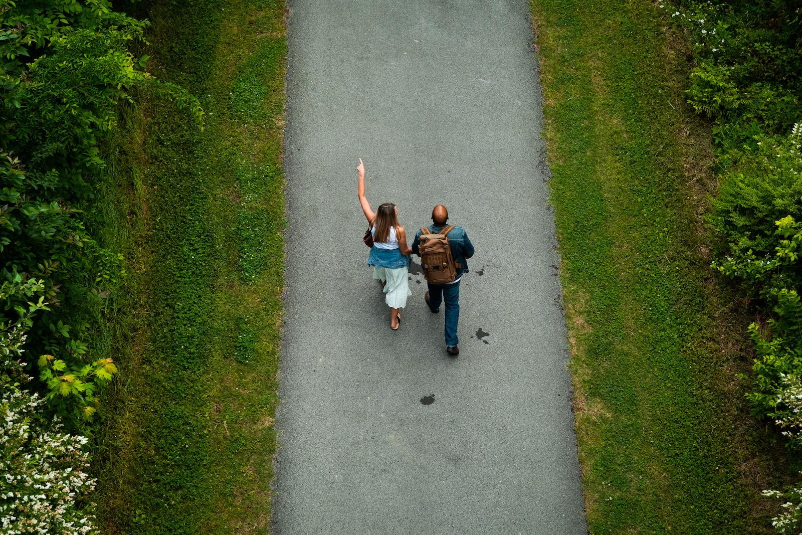 Two people go for walk along a path